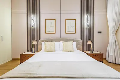 a bedroom with a large white bed with two lamps at Elegant Oasis - 15 min to Burj Khalifa and Aiport - 1 BDR - 4 pax in Dubai