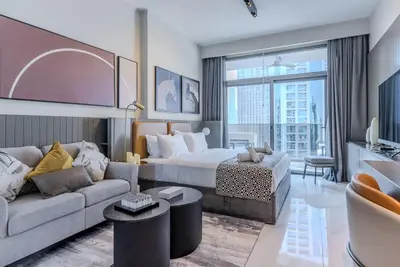 a hotel room with a bed and a couch at TRPS - MAG 318, Business Bay - Spacious Studio, Furnished, Close to Dubai Mall in Dubai