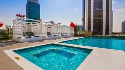 a swimming pool on the roof of a building at TRPS - MAG 318, Business Bay - Spacious Studio, Furnished, Close to Dubai Mall in Dubai