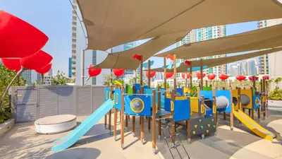 a playground with a slide in a city at TRPS - MAG 318, Business Bay - Spacious Studio, Furnished, Close to Dubai Mall in Dubai