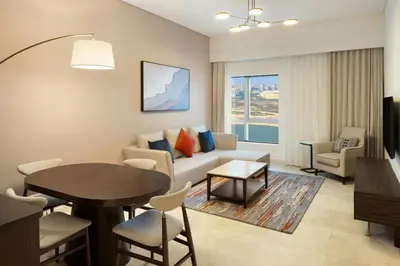 a living room with a couch and a table at Vintage Grand Hotel Apartments Dubai in Dubai