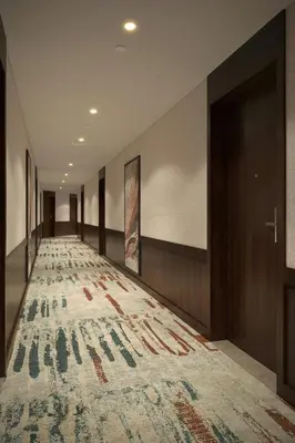 a hallway with a large rug on the floor at Vintage Grand Hotel Apartments Dubai in Dubai