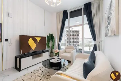 a living room with a couch and a tv at Vogue Arjan Opalz by Danube near Science Park, One Bedroom Apartment with Balcony and Vibrant Community View, Access to all Amenitties in Dubai