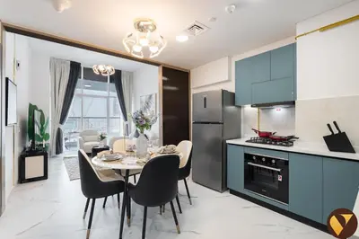a kitchen and dining room with a table and chairs at Vogue Arjan Opalz by Danube near Science Park, One Bedroom Apartment with Balcony and Vibrant Community View, Access to all Amenitties in Dubai