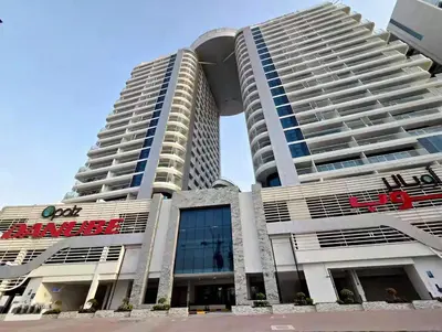 a large white building with a sign on it at Vogue Arjan Opalz by Danube near Science Park, One Bedroom Apartment with Balcony and Vibrant Community View, Access to all Amenitties in Dubai