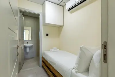 a white bedroom with a bed and a sink at Maison Privee - Chic & Eclectic Family Home with Park Vws in Meydan in Dubai