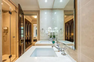 a bathroom with two sinks and a large mirror at Charming 1 BR with Burj Khalifa View in Dubai