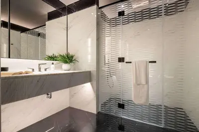 a bathroom with a shower with a glass door at Frank Porter - J One Tower 2 in Dubai