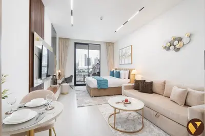 a living room with a couch and a bed at Vogue JVC Binghatti Dawn near Circle Mall, Studio Apartment with Balcony and Vibrant Community View, Access to all Amenities in Dubai