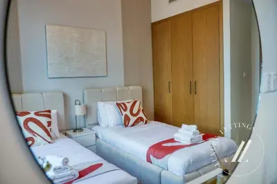a bedroom with two beds and a mirror at Luxury 2BR Harbour Views Tower 2 Creek Harbour Dubai in Dubai