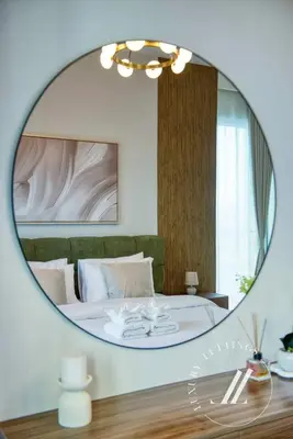 a bedroom with a large circular mirror in a room at Luxury 2BR Harbour Views Tower 2 Creek Harbour Dubai in Dubai