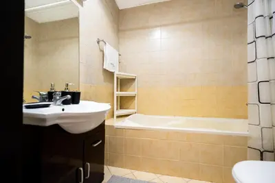 a bathroom with a sink and a tub at Escape24 Elegant 1BR with Marina Views, Dubai Marina in Dubai