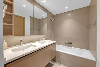 a bathroom with two sinks and a tub and a mirror at 3 Bedroom in Creek Habour with Scenic Views for Family and Solo Travelers in Dubai