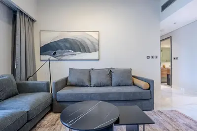a living room with a couch and a table at TRPS - MAG 318, Business Bay - Pool View, 2BR Fully Furnished, Prime Location in Dubai