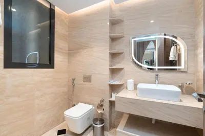 a bathroom with a white sink and a mirror at Samaya Holiday Homes - Square 1B Duplex Panoramic View in Dubai