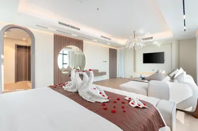 a bedroom with a bed with two swans decorations on it at Samaya Holiday Homes - Square 1B Duplex Panoramic View in Dubai