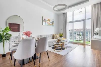 a living room with a table and a couch at Frank Porter - Glitz Residence 2 in Dubai