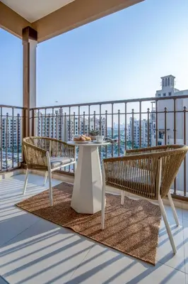 a balcony with two chairs and a table on a balcony at Frank Porter - Jadeel 3 in Dubai