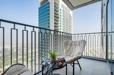 a balcony with a chair on top of a building at Frank Porter - Downtown Views II Tower 1 in Dubai