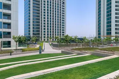 a park in a city with tall buildings at Frank Porter - Downtown Views II Tower 1 in Dubai