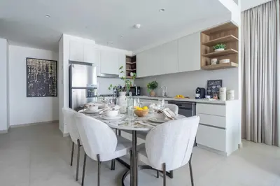 a kitchen with a table and chairs in a kitchen at Frank Porter - Downtown Views II Tower 1 in Dubai