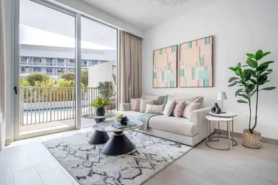 a living room with a couch and a large window at Frank Porter - Luma22 West Tower in Dubai