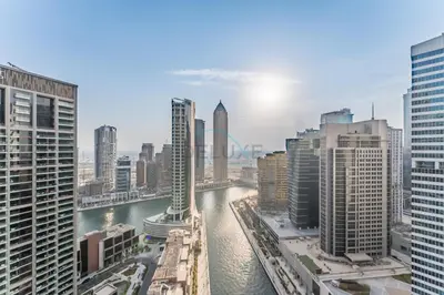 a view of a city with a river and buildings at Studio with Dubai Canal View, Walking Distance to Metro Station and Near Downtown Dubai - Peninsula One, Business Bay by Deluxe Holiday Homes in Dubai