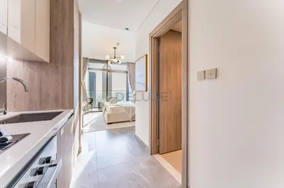 a kitchen with a door leading to a living room at Studio with Dubai Canal View, Walking Distance to Metro Station and Near Downtown Dubai - Peninsula One, Business Bay by Deluxe Holiday Homes in Dubai