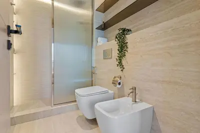 a bathroom with a toilet and a sink and a shower at The Smart Concierge - Bay Central in Dubai