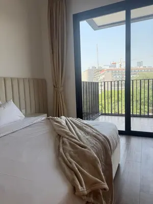 a bedroom with a bed and a large window at Oakley Square Residence in Dubai