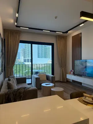 a living room with a couch and a flat screen tv at Oakley Square Residence in Dubai