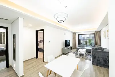 a living room with a table and a couch at Escape24 Elegant 1BR in JVC with Pool View in Dubai