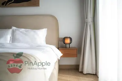 a bedroom with a bed with an apple on it at Beautiful Brand New Spacious in Dubai