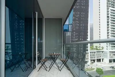 a balcony with a table and chairs on a building at Chic and Urban 1-Bed Business Bay Suite in Dubai
