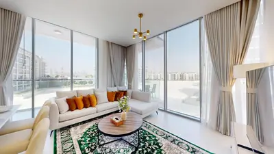 a living room with a white couch and large windows at Vacationer l Serene 3 Bed Haven l Private Beach l District One in Dubai