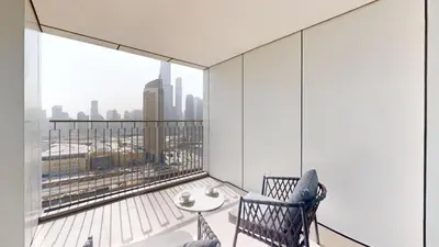 an apartment balcony with a view of the city at Vacationer I Luxury 3 Bedroom Apartment I Iconic Burj Khalifa View I Heart of Downtown in Dubai