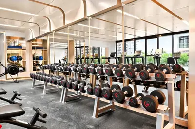 a gym with rows of dumbbells on display at Apartamento Dune en Dubái por beBalmy in Dubai