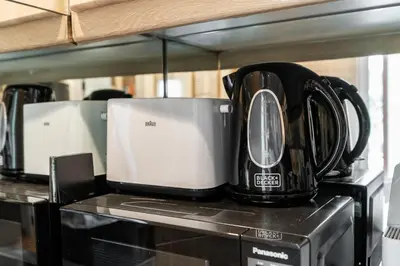 a group of appliances sitting on top of a counter at Palmoral Collection Stunning Studio with Dining Area in Dubai