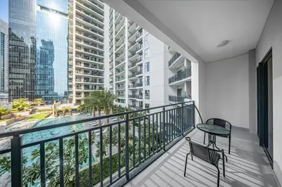 a balcony with a table and chairs and a view of the city at Stylish & Elegant Stay Prime Business Bay Spot in Dubai
