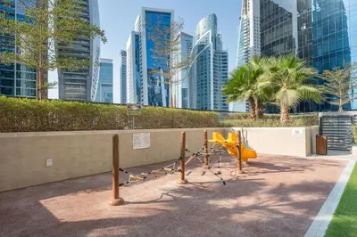 a playground in a city with tall buildings at Stylish & Elegant Stay Prime Business Bay Spot in Dubai