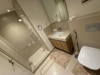 a bathroom with a shower and a toilet and a sink at Luxury Apartment Downtown views 2 in Dubai