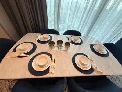 a wooden table with plates and hats on it at Luxury Apartment Downtown views 2 in Dubai