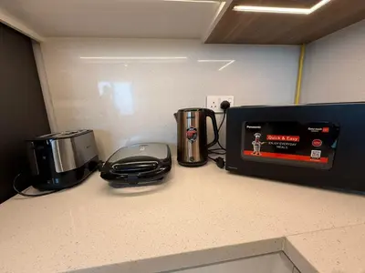 a counter top with a coffee maker and a toaster at Luxury Apartment Downtown views 2 in Dubai