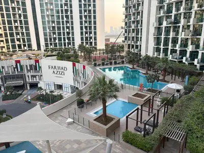 an aerial view of a resort with two pools and buildings at Deluxe studio water front in Dubai