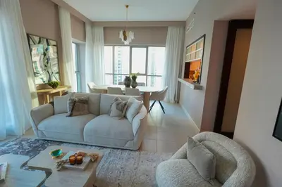 a living room with a couch and a table at Luxury Family Friendly Apartment - Full Burj Khalifa & Fountain Views in Dubai