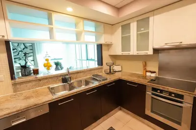 a kitchen with a sink and a window at Luxury Family Friendly Apartment - Full Burj Khalifa & Fountain Views in Dubai