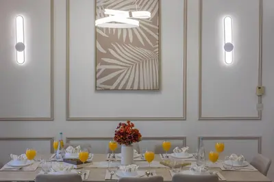 a dining room with a table with chairs and a picture at JBR Saddaf 4 By Luxe Living - Marina & Sea Views in Dubai