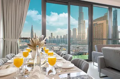 a dining room with a view of a city at Downtown Views By Luxe Living - Full Burj Khalifa Views in Dubai