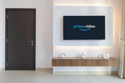 a tv on a wall in a room with a door at Downtown Views By Luxe Living - Full Burj Khalifa Views in Dubai
