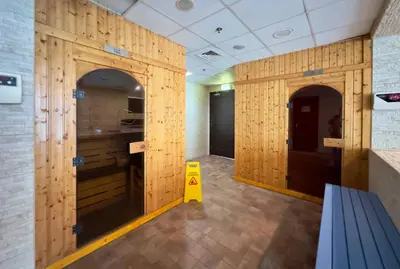 a room with wooden walls and a yellow object in it at Modern & Cozy 1BR Apartment | Dubai Eye View in Dubai